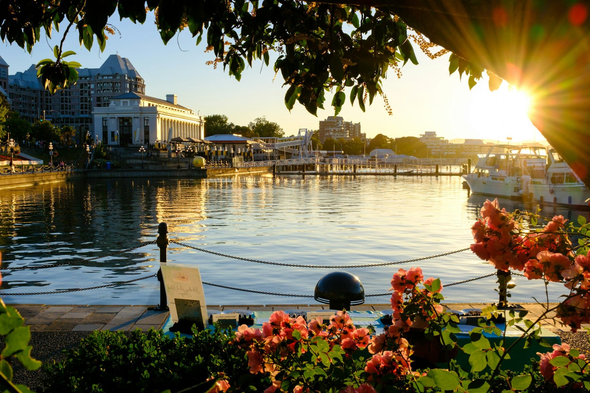 Victoria Inner Harbour at golden hour with the Empress Hotel and flowers along the waterfront